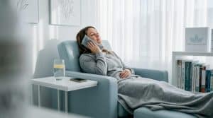 Woman applying cold compress after filler treatment