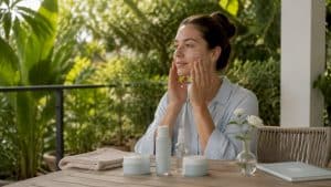 Woman applying moisturizer before laser treatment