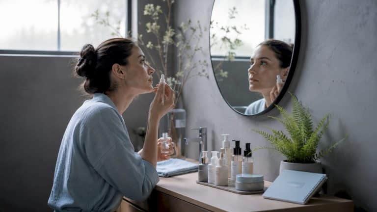 Woman applying personalized skincare in bathroom