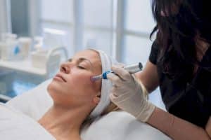 Close-up of microneedling device on facial skin