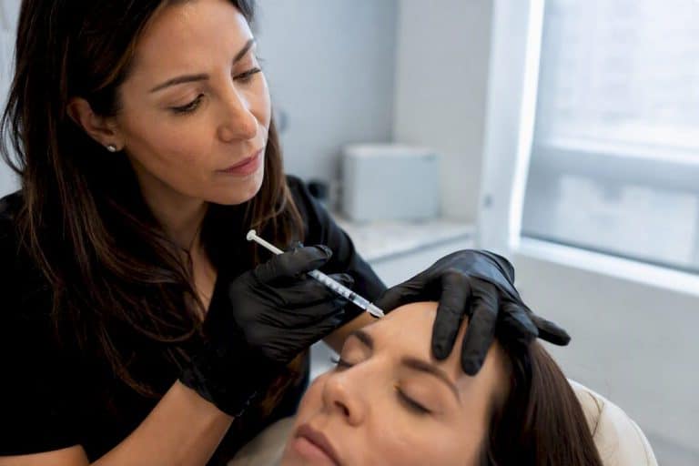 Clinician preparing Botox injection for forehead