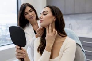 Clinician assessing patient's jawline