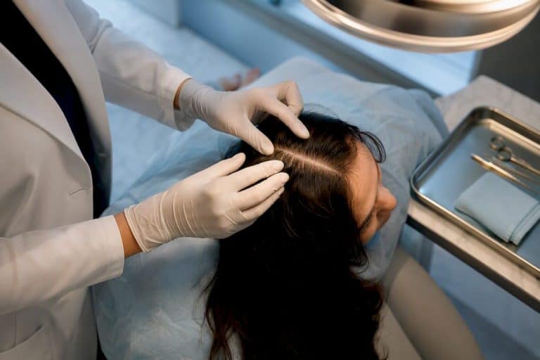 Clinician examining scalp for hair restoration