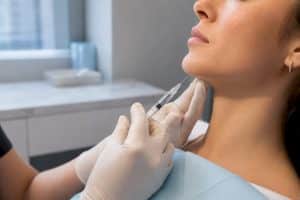 Clinician performing precise chin filler injection