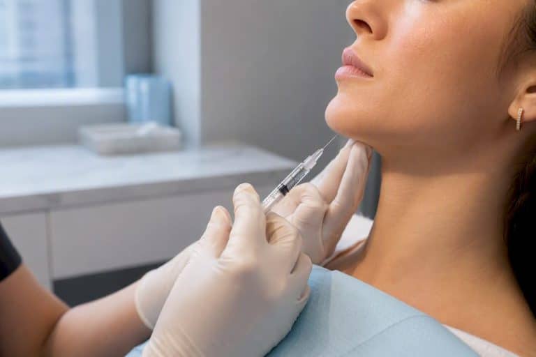 Clinician performing precise chin filler injection