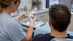 Injector verifying Botox before forehead treatment