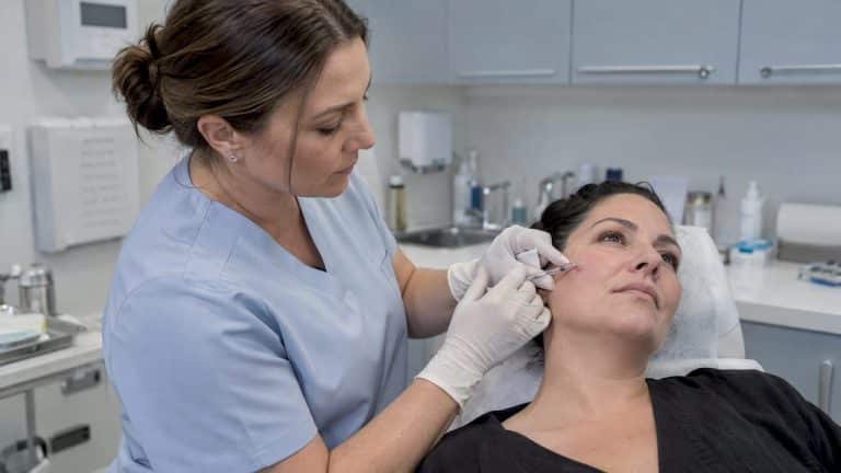 Injector performing a dermal filler treatment